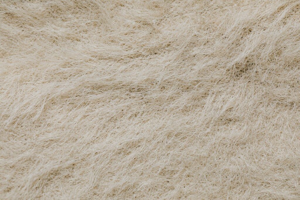 High-resolution close-up of a textured surface with beige natural fibers forming intricate patterns.