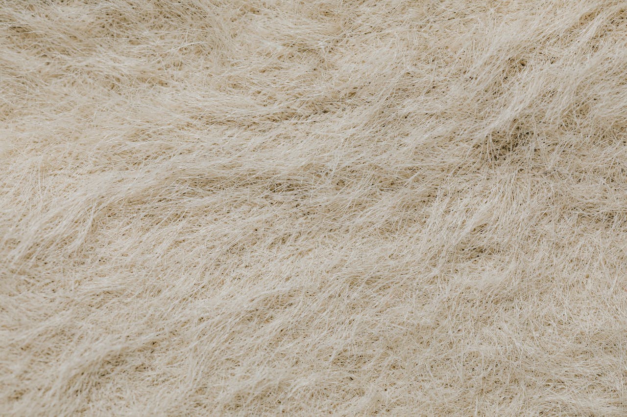 High-resolution close-up of a textured surface with beige natural fibers forming intricate patterns.